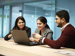 people holding umbrellas on a busy street at night lit by street lights and illuminated signs in Tokyo, Japan
