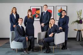car interior from central back seat position showing driver and blurred view through windscreen of a busy road at night