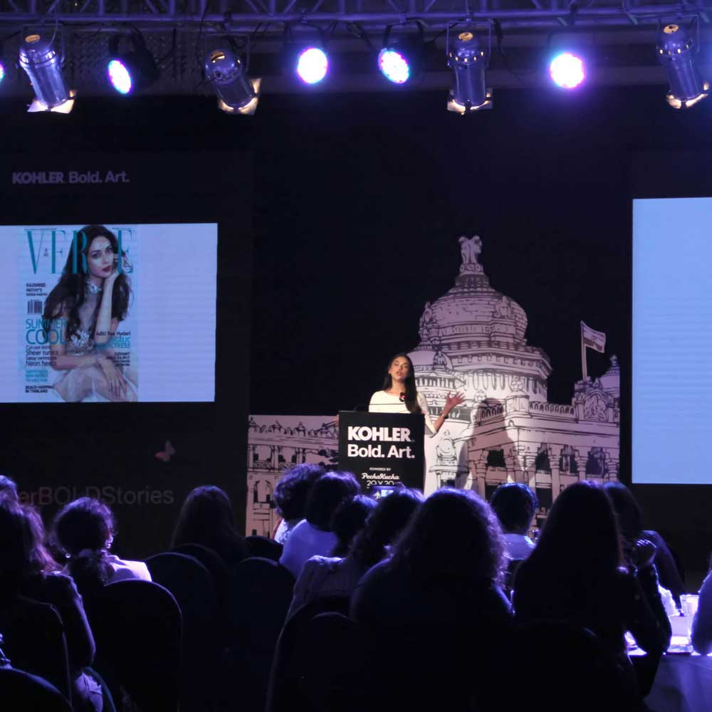 people holding umbrellas on a busy street at night lit by street lights and illuminated signs in Tokyo, Japan