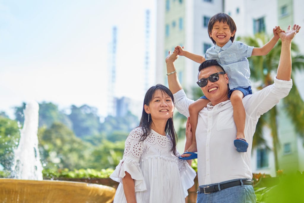 people holding umbrellas on a busy street at night lit by street lights and illuminated signs in Tokyo, Japan